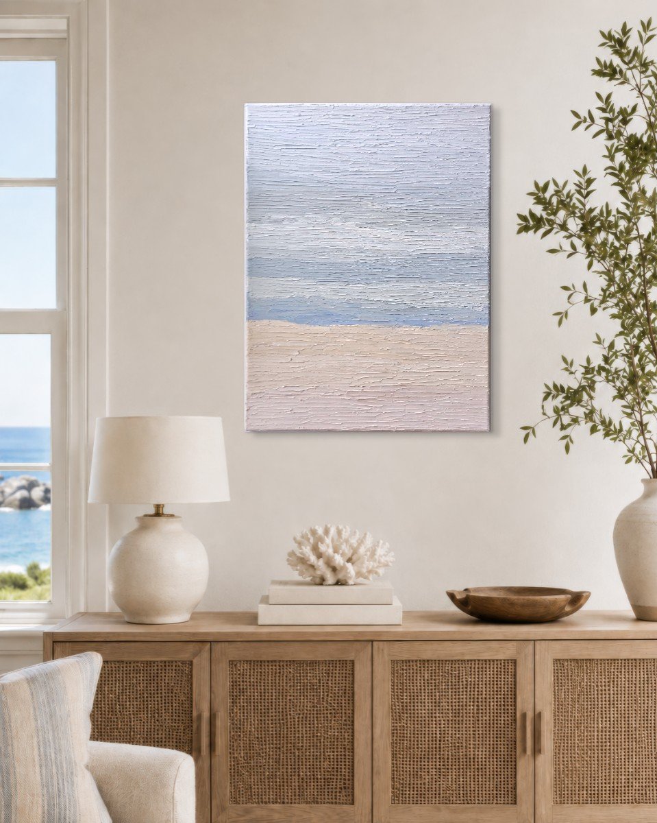 Stillness hung above a cane sideboard in a coastal room